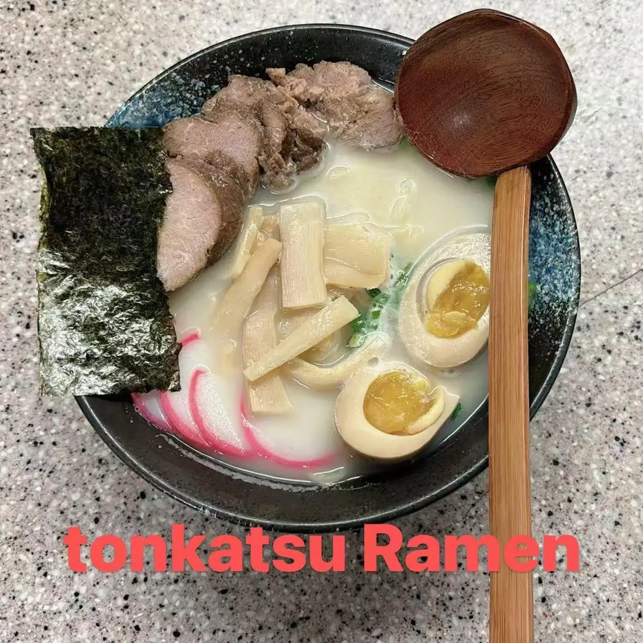 Tonkatsu ramen with pork slices, noodles, soft - boiled eggs, bamboo shoots, and seaweed in broth at FUJI SAN Japanese restaurant in Vestal