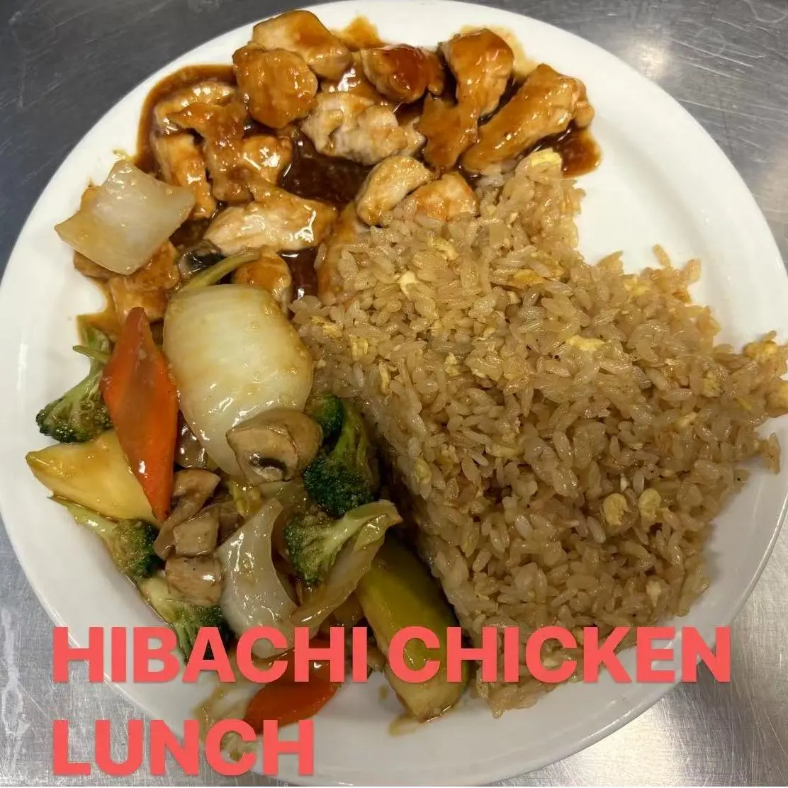 Hibachi chicken lunch with fried rice, mixed vegetables, and savory chicken in sauce at FUJI SAN Japanese restaurant in Vestal