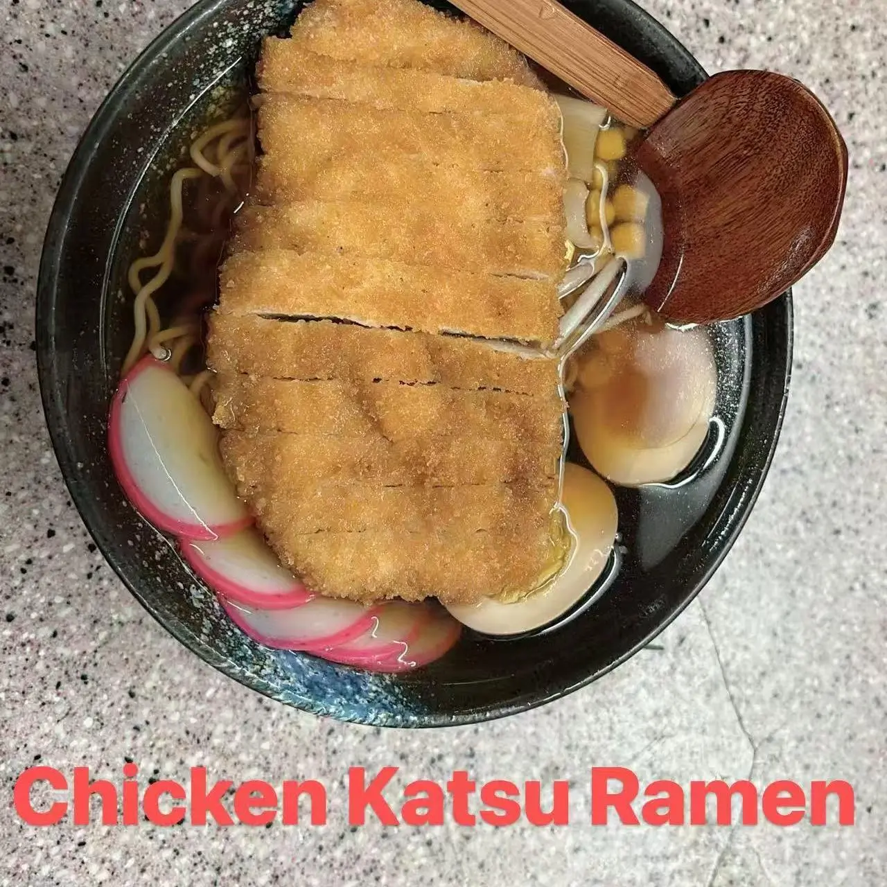 Ramen with crispy chicken katsu, noodles, pickled radish, and soft - boiled eggs in broth at FUJI SAN Japanese restaurant in Vestal